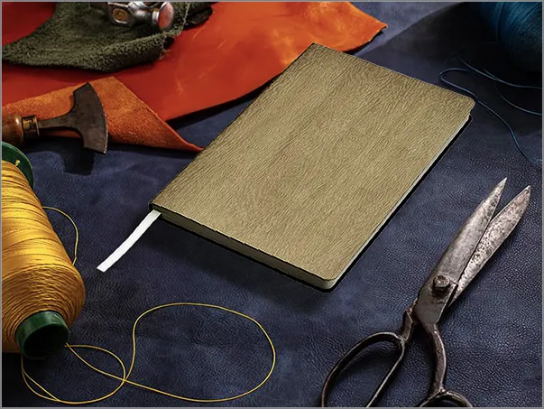 A book and some scissors on a table.